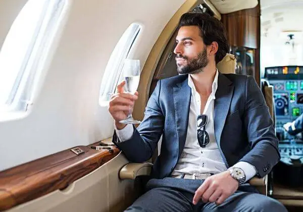 Man in a suit sitting in a private jet