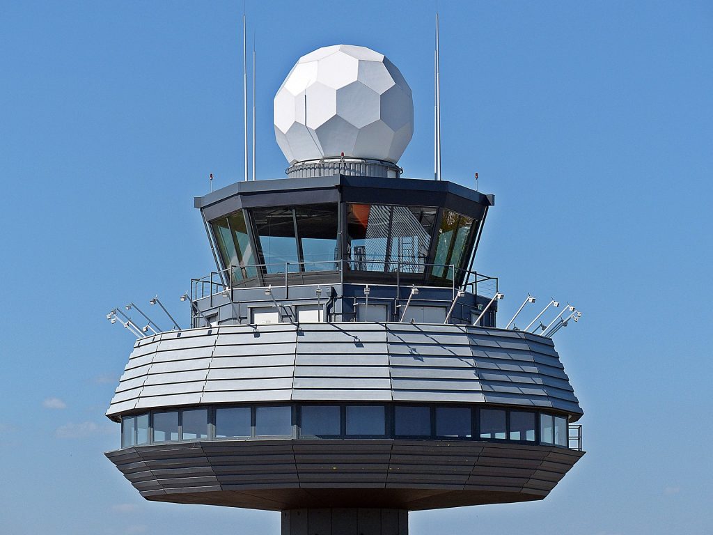 Air traffic control tower communicating with private jets and other aircraft