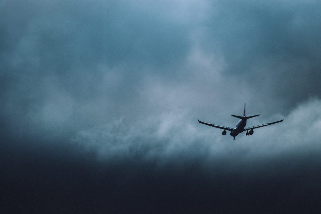 private jet flying high above bad weather