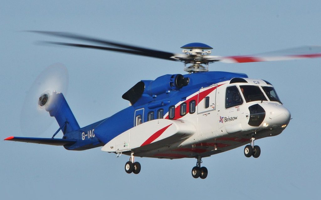 An image of a blue and white private helicopter