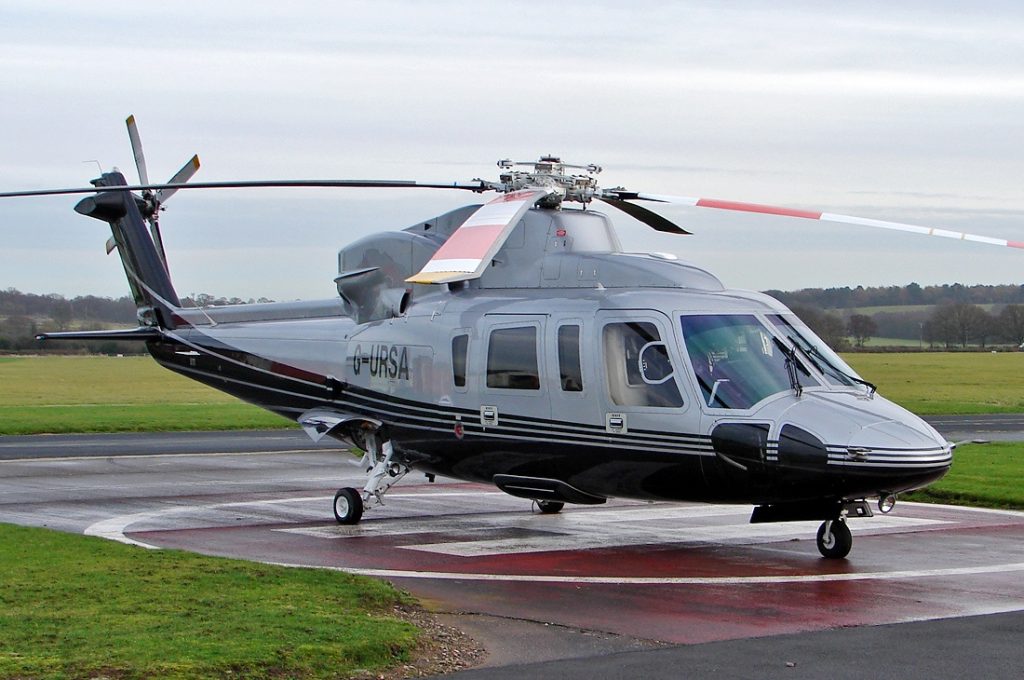 An image of a grey private helicopter landing